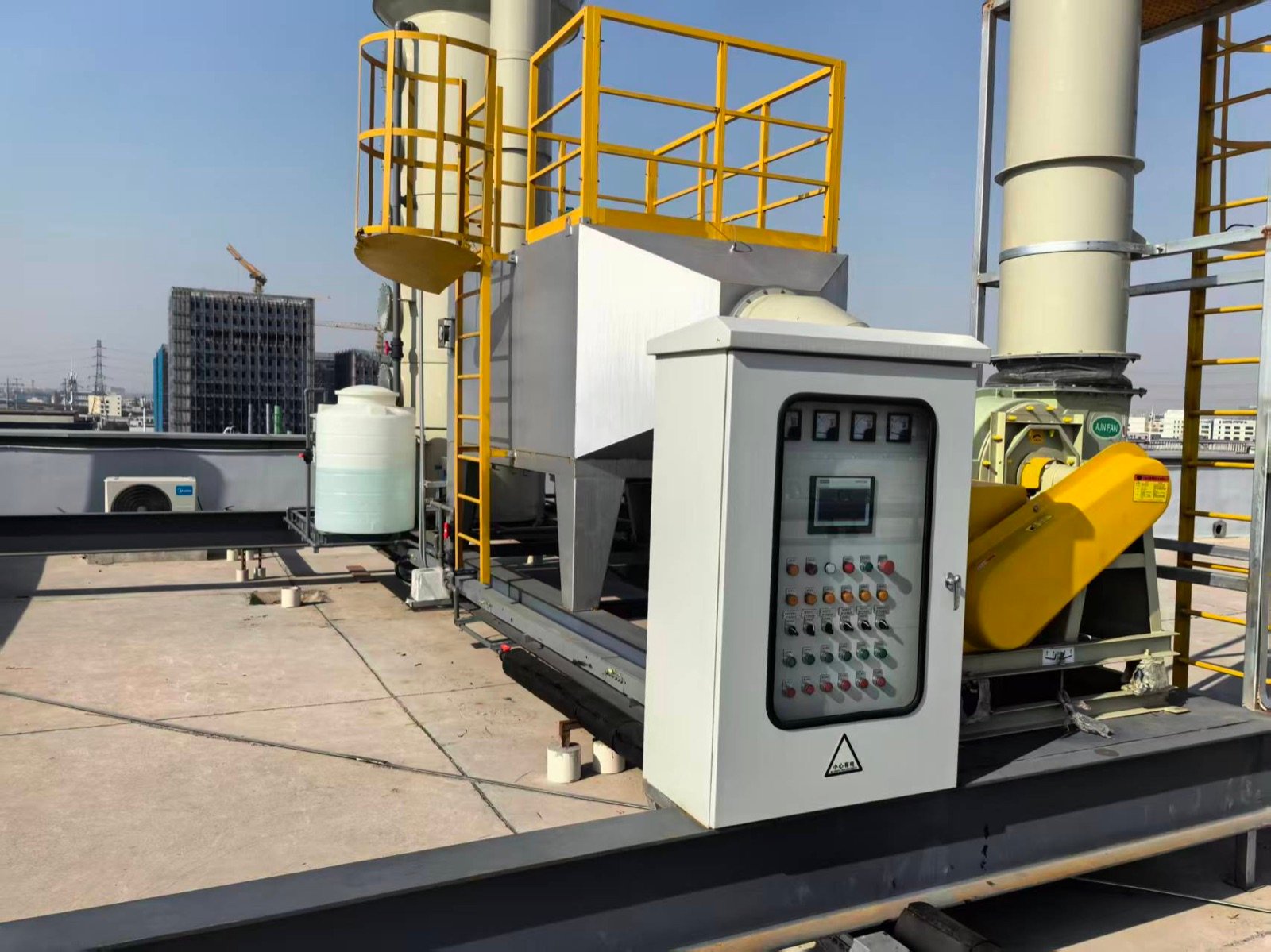 Pharmaceutical exhaust scrubber and control cabinet installed on a factory rooftop